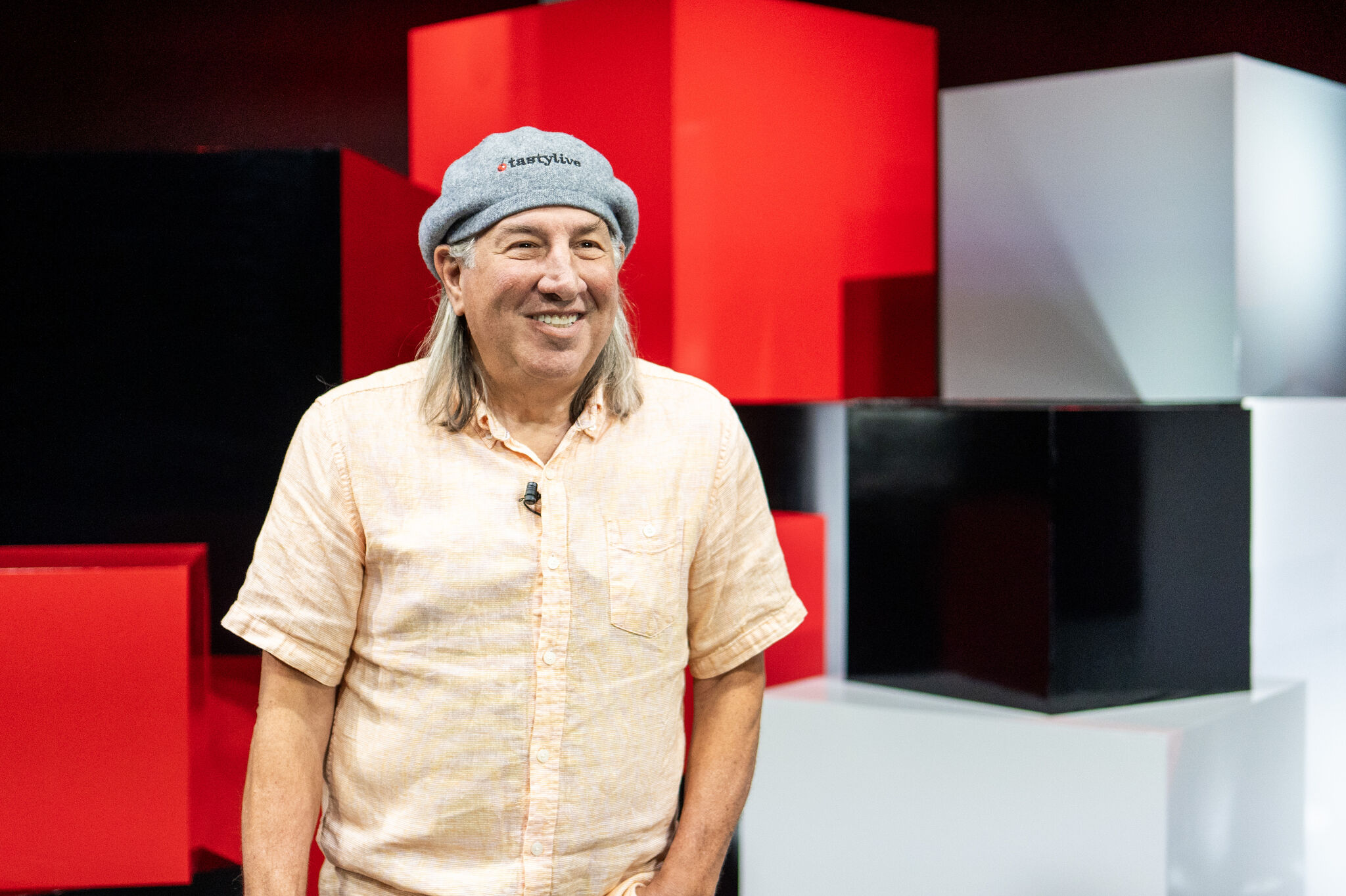 An executive speaking on a red-and-white branded studio set