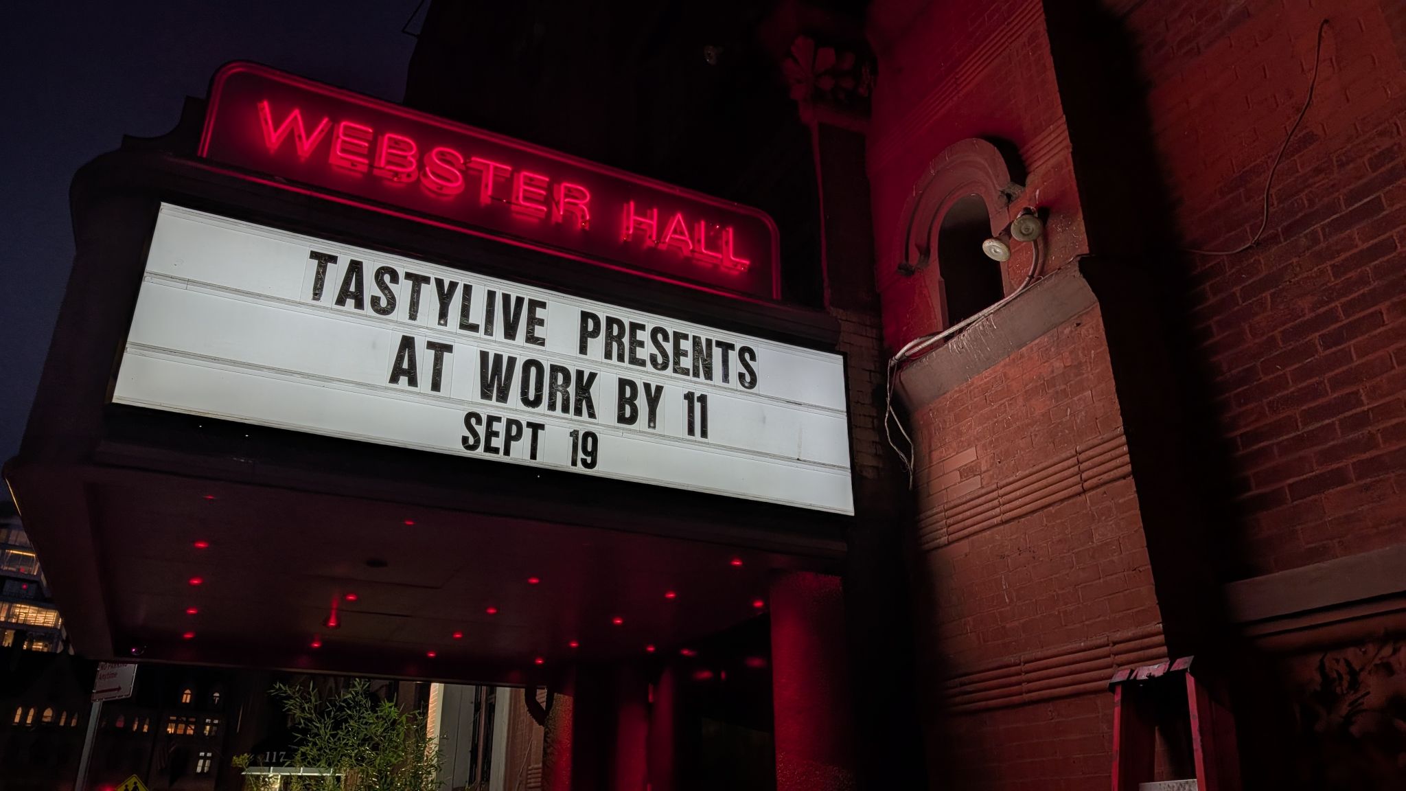 The Webster Hall marquee lit up in red at night, reading TASTYLIVE PRESENTS AT WORK BY 11 SEPT 19
